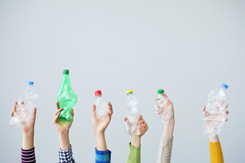 hands holding up plastic bottles