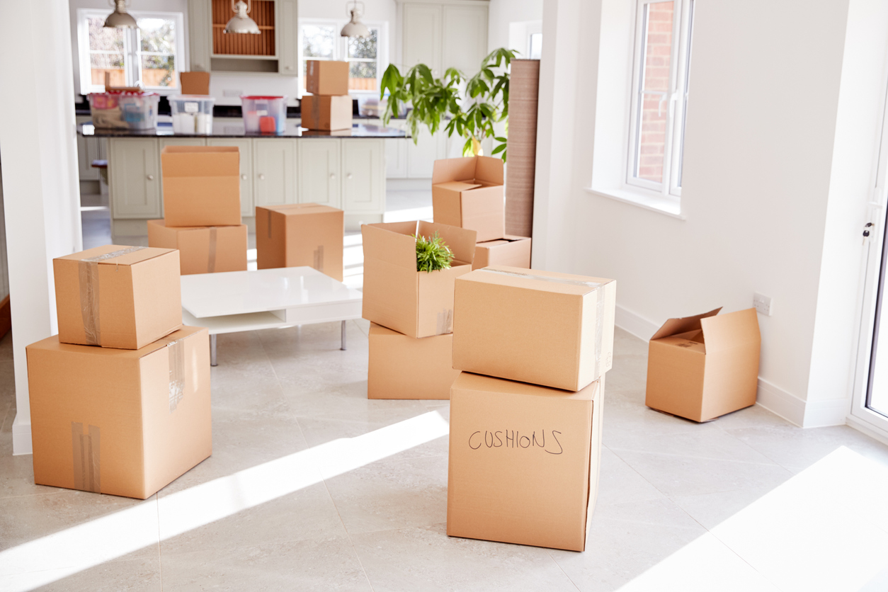 Stacked Removal Boxes In Empty Room On Moving Day